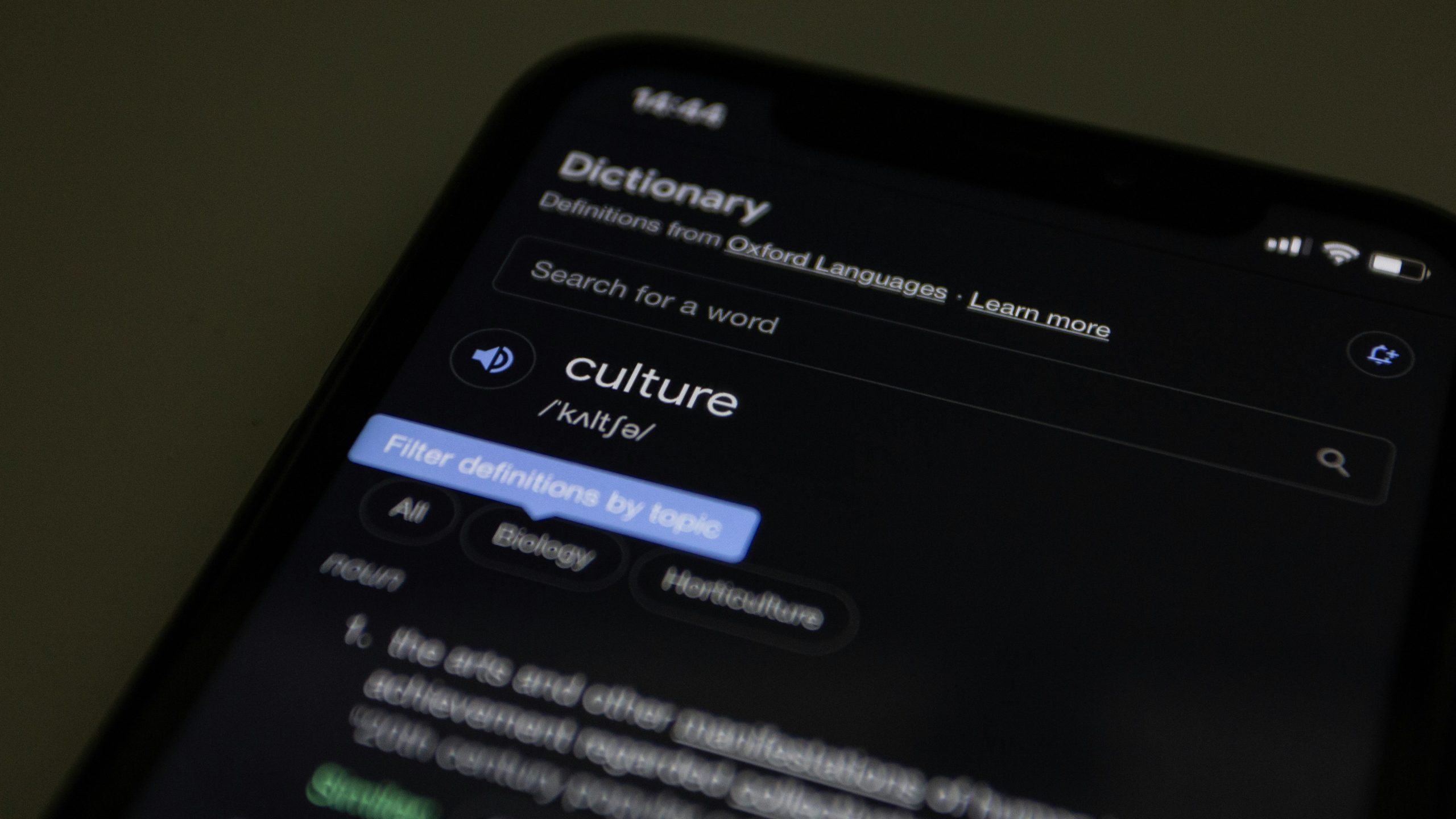 A photo of a phone screen, with a dictionary app open at the word "culture"