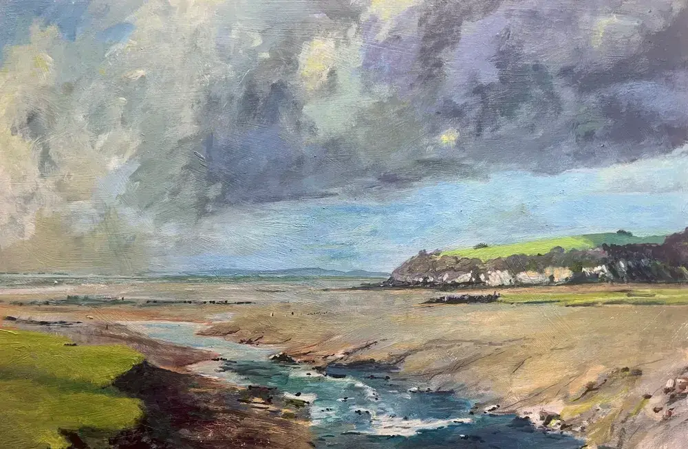 A painting of the estuary at Clevedon. The sky is heavy with moody clouds, and there is light and shade playing across the landscape.